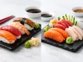 Dwa talerze z różnorodnym sushi i sashimi: łosoś, tuńczyk, krewetka, węgorz, biała ryba. Podane z wasabi i imbirem.