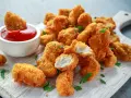Chrupiące krewetki w panko, idealne do maczania w ketchupie. Pyszna przekąska na każdą okazję.