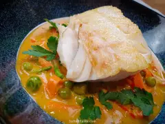 Aromatyczny curry z dorszem, podane z groszkiem i marchewką w kremowym sosie.